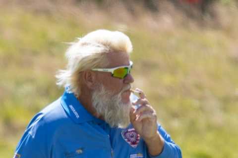 John Daly puffs cigarette while practicing for The Open after winning over fans with Past Champions Dinner suit