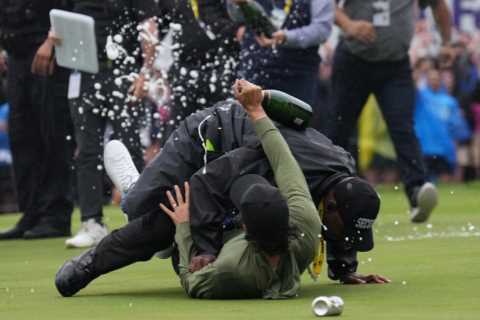 Watch pro golfer ranked top 70 in world get TACKLED by security guard who mistakes him for a fan as he celebrates