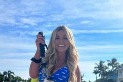 Glam golfer Emily Faulkner tries hand at new sport as she shows off huge catch and fans brand her ‘mermaid with a fish’