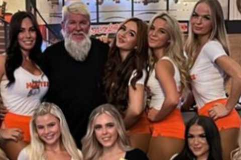 Former Open champion John Daly hangs out in Hooters with host of busty waitresses after missing the cut at Hoylake